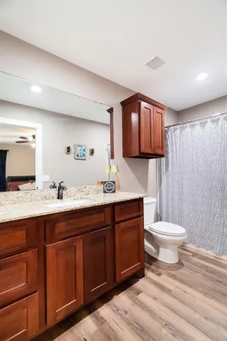a bathroom with a double vanity sink toilet and a mirror
