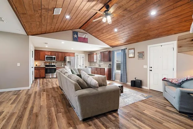a living room with furniture and kitchen view