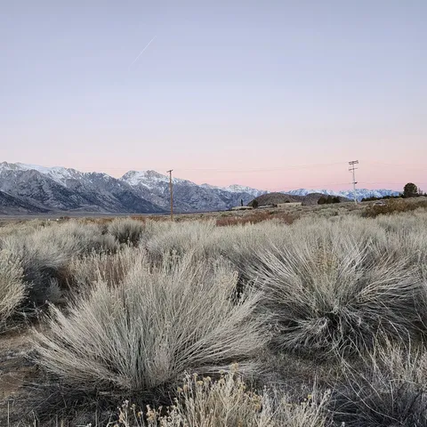 a view of mountain with sunset background