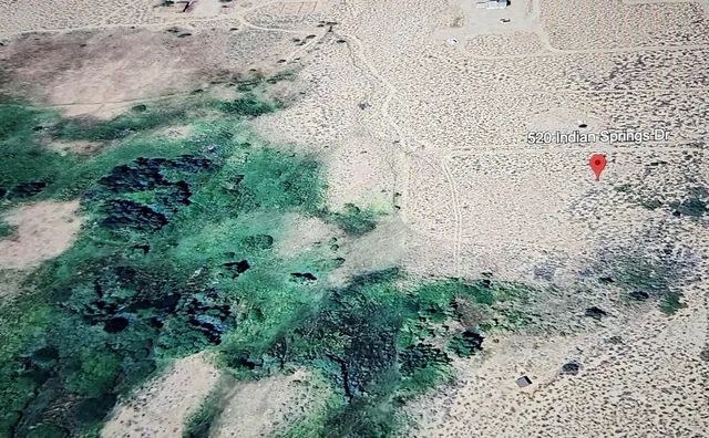 a view of mountains in middle of forest