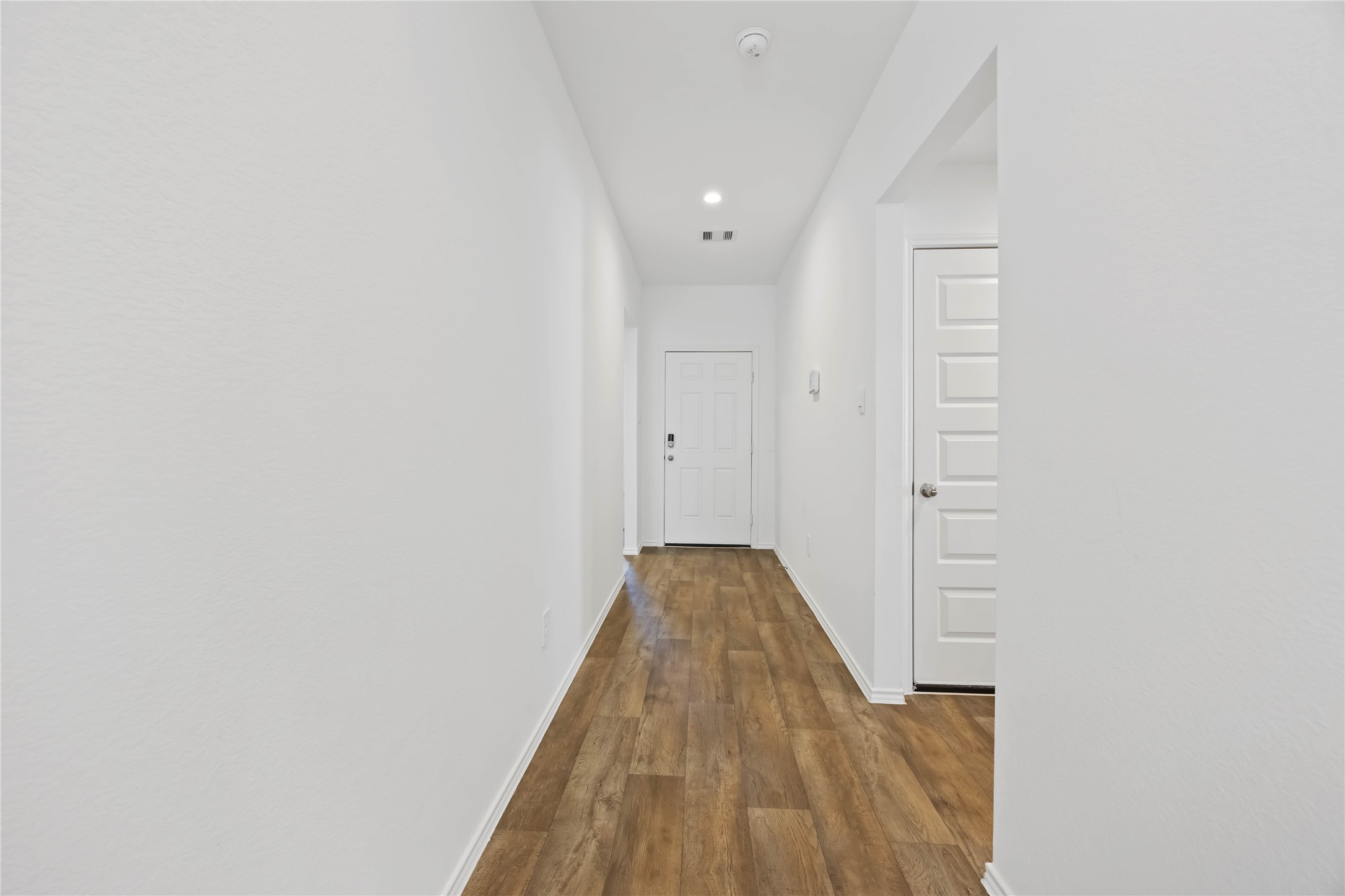 3719 Lanercost Lane Fulshear, TX 77441 - Photo 3 of 43 a view of a hallway with wooden floor