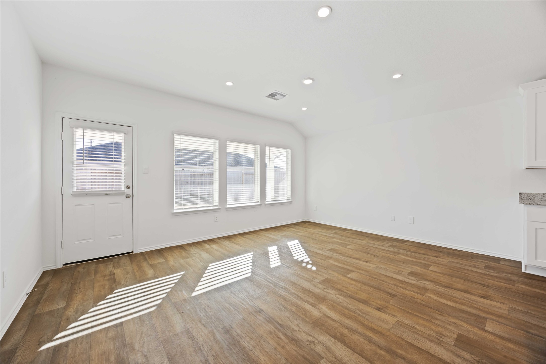 3719 Lanercost Lane Fulshear, TX 77441 - Photo 6 of 43 a view of an empty room with wooden floor and a window