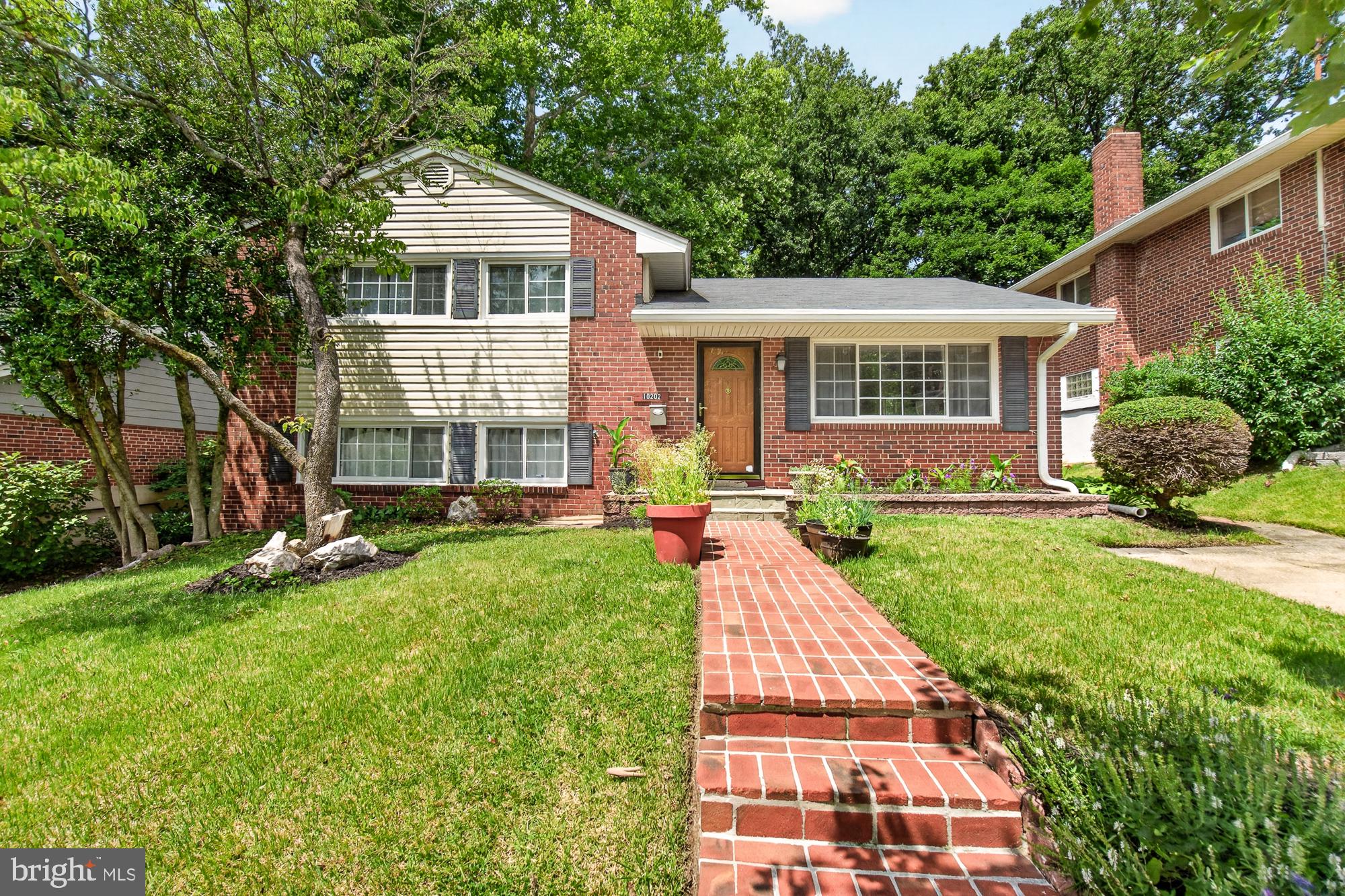 10202 Leslie Street Silver Spring, MD 20910 - Photo 1 of 44 Charming brick home with lush greenery.