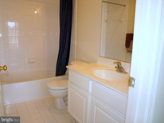 46182 Chester Terrace Sterling, VA 20165 - Photo 19 of 25 a bathroom with a sink toilet and shower