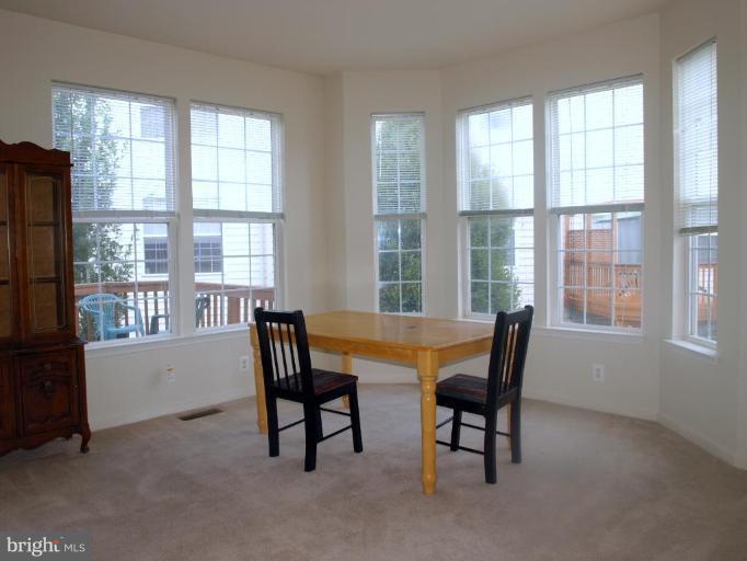 46182 Chester Terrace Sterling, VA 20165 - Photo 8 of 25 a view of a dining room with furniture and windows