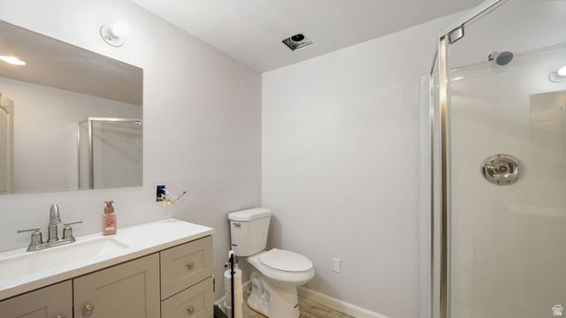 6062 Spring Street Stansbury Park, UT 84074 - Photo 21 of 36 Bathroom featuring a single vanity with a white countertop, chrome faucet, and a large wall-mounted mirror