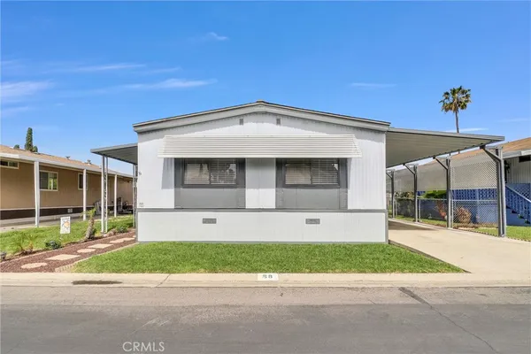 a front view of a house with a garden and a garage