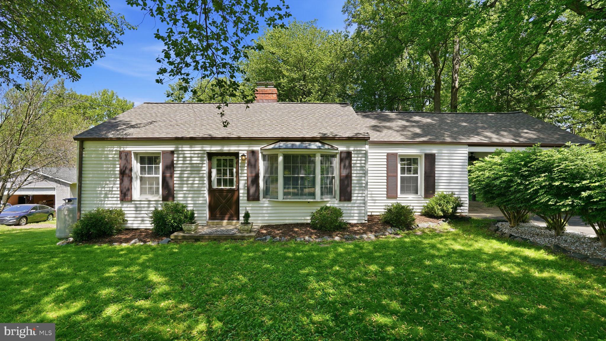 a front view of a house with garden and porch