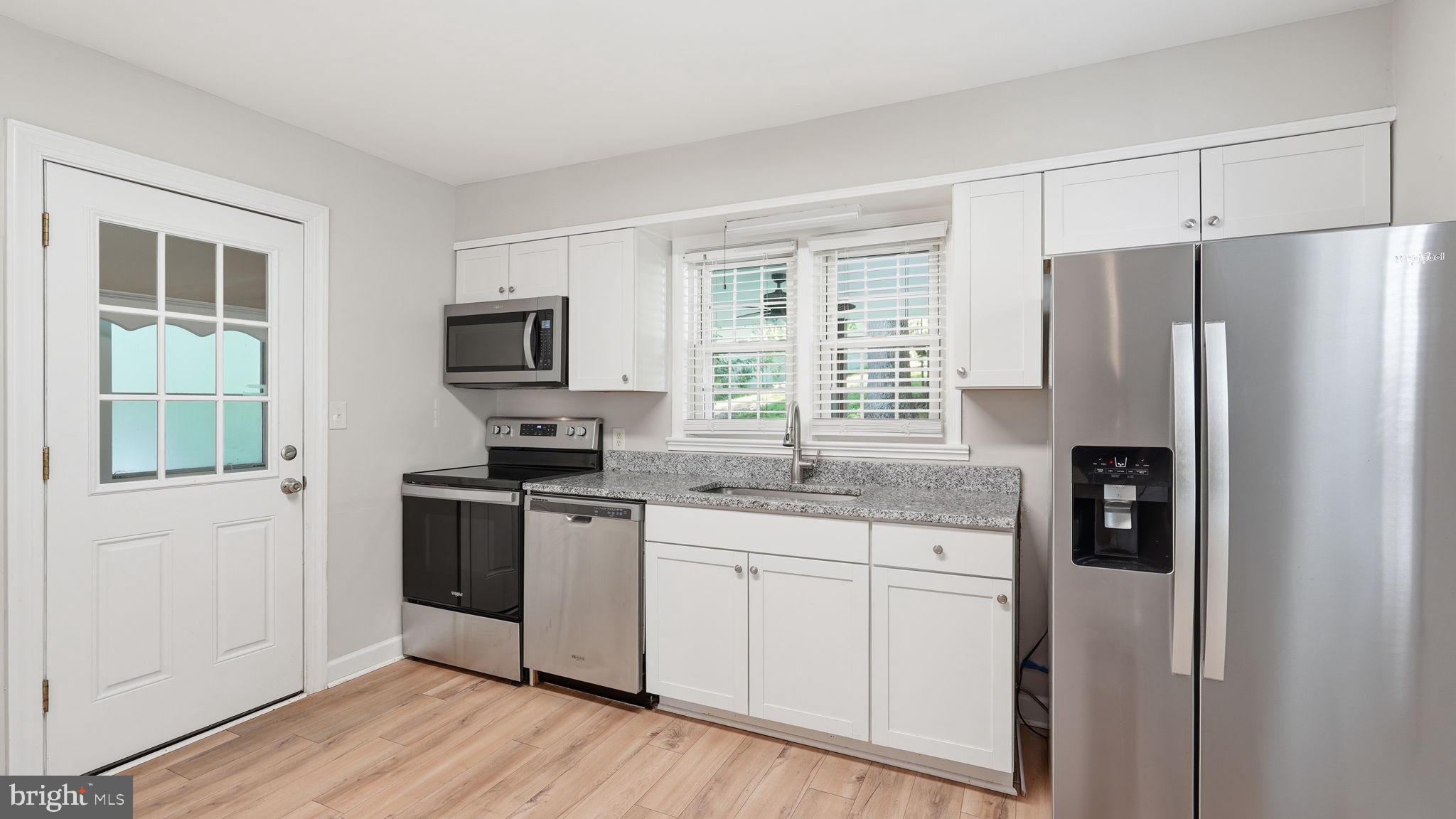 6499 Briggs Road Warrenton, VA 20187 - Photo 11 of 29 a kitchen with stainless steel appliances granite countertop a refrigerator a stove a sink and a microwave