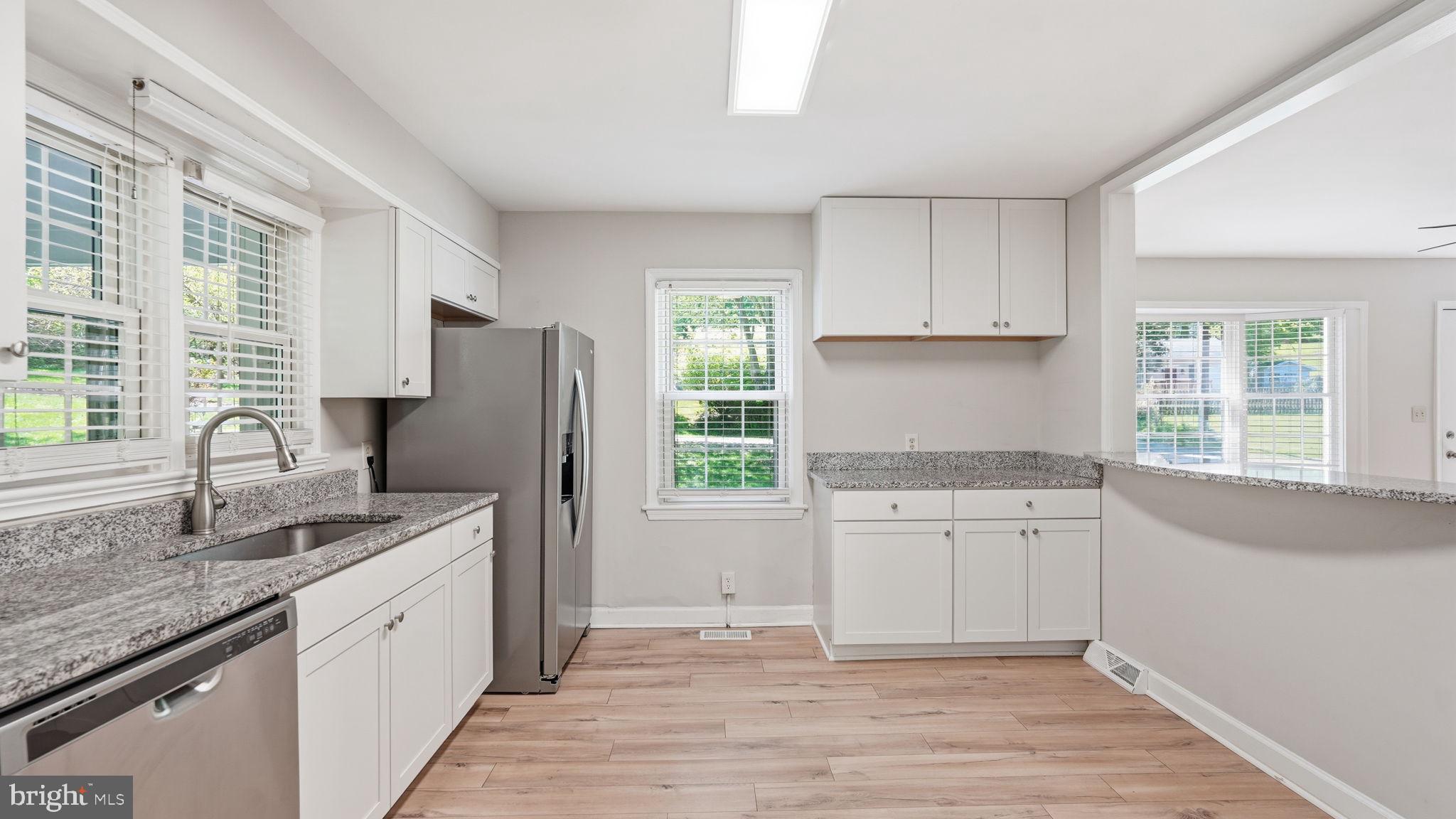 6499 Briggs Road Warrenton, VA 20187 - Photo 12 of 29 a kitchen with granite countertop a sink stove and refrigerator