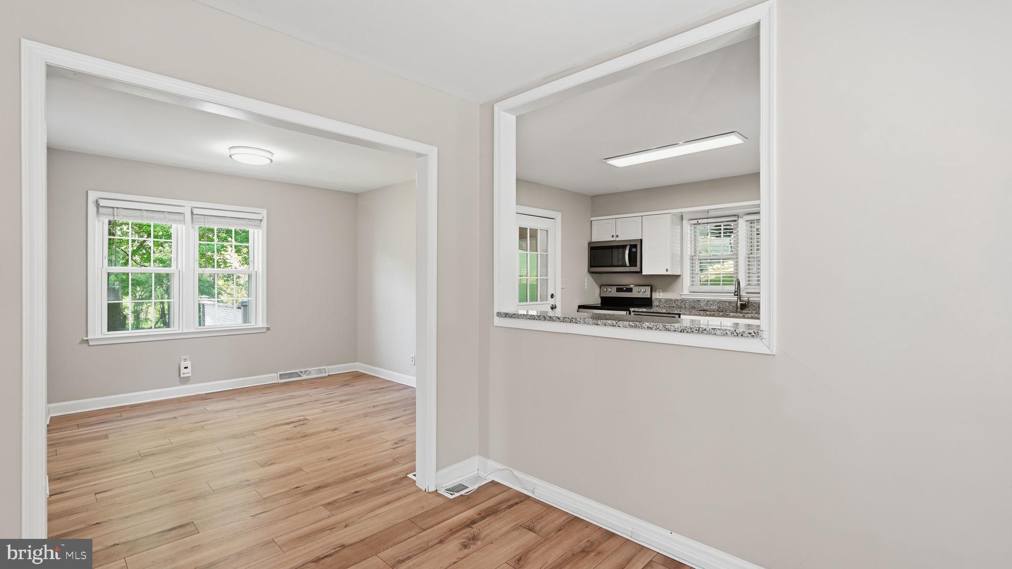 6499 Briggs Road Warrenton, VA 20187 - Photo 14 of 29 a view of kitchen with wooden floor electronic appliances and window