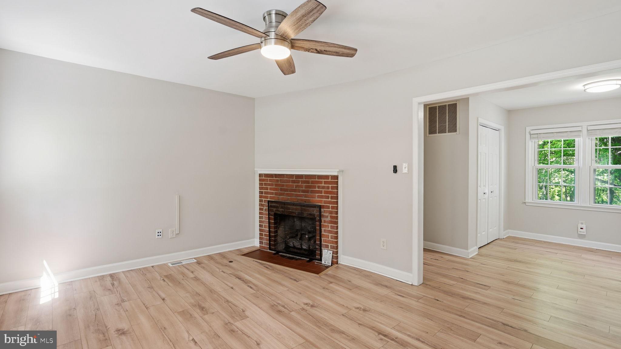 6499 Briggs Road Warrenton, VA 20187 - Photo 15 of 29 an empty room with wooden floor a ceiling fan and windows