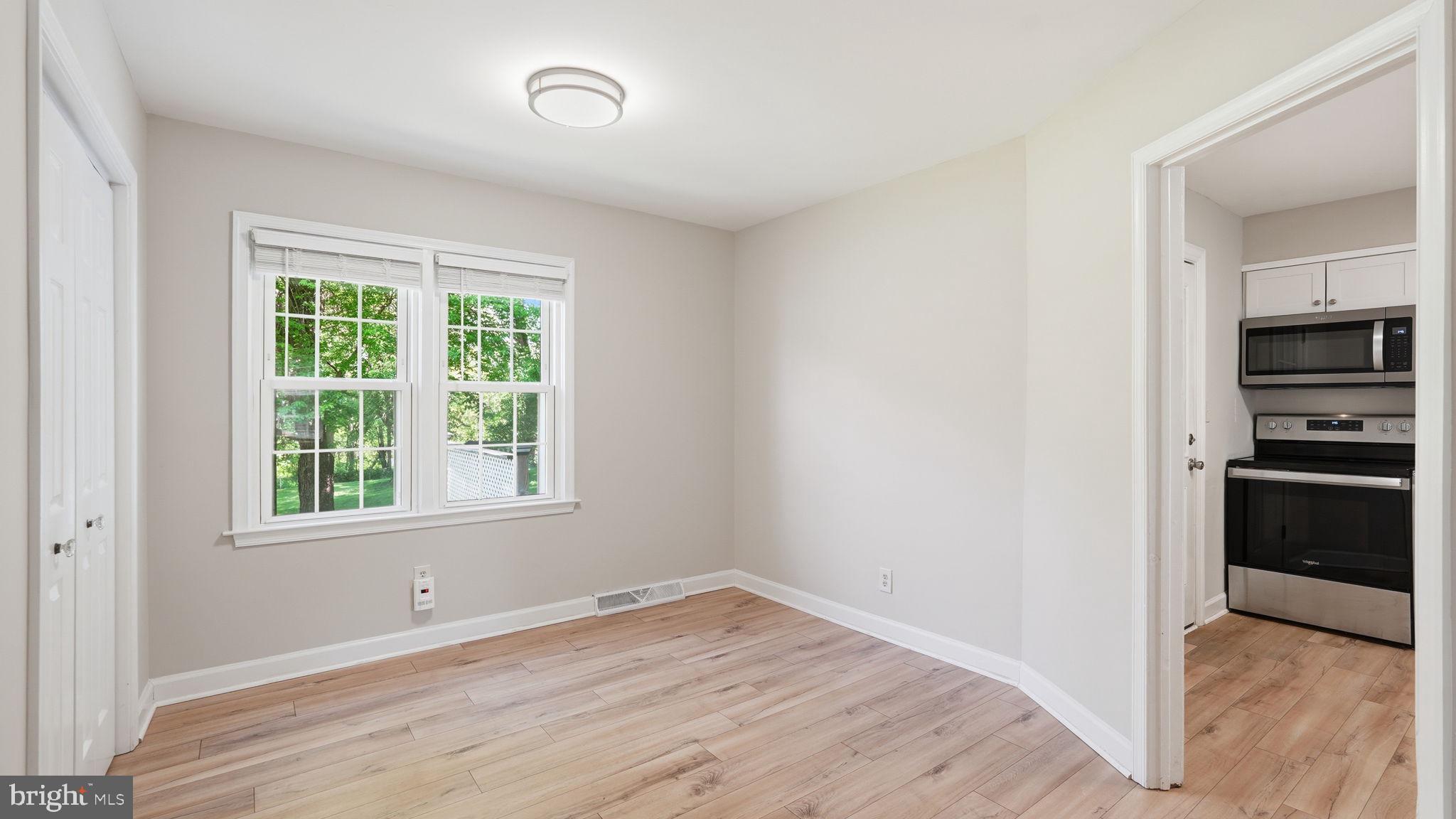 6499 Briggs Road Warrenton, VA 20187 - Photo 16 of 29 an empty room with a window and a kitchen view
