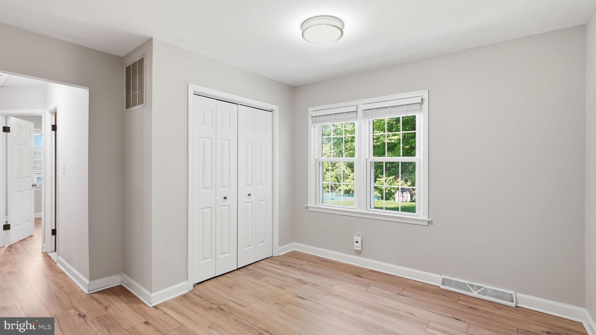 6499 Briggs Road Warrenton, VA 20187 - Photo 17 of 29 an empty room with wooden floor and windows