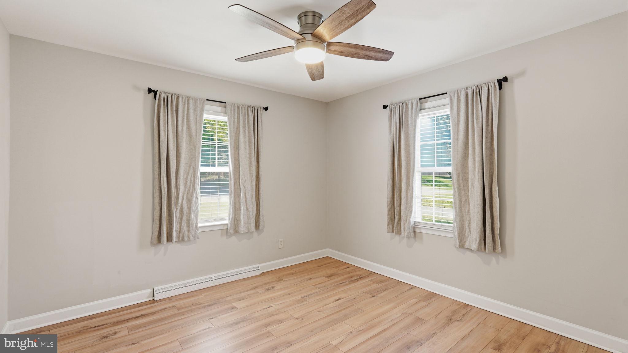 6499 Briggs Road Warrenton, VA 20187 - Photo 18 of 29 a view of empty room with wooden floor and fan