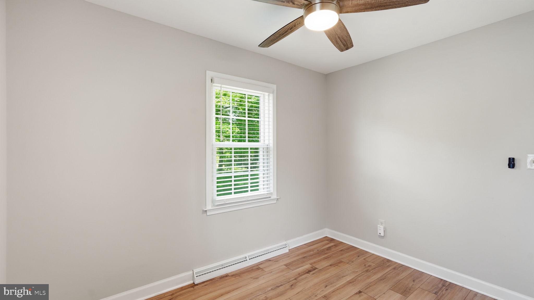 6499 Briggs Road Warrenton, VA 20187 - Photo 20 of 29 an empty room with a window and a fan