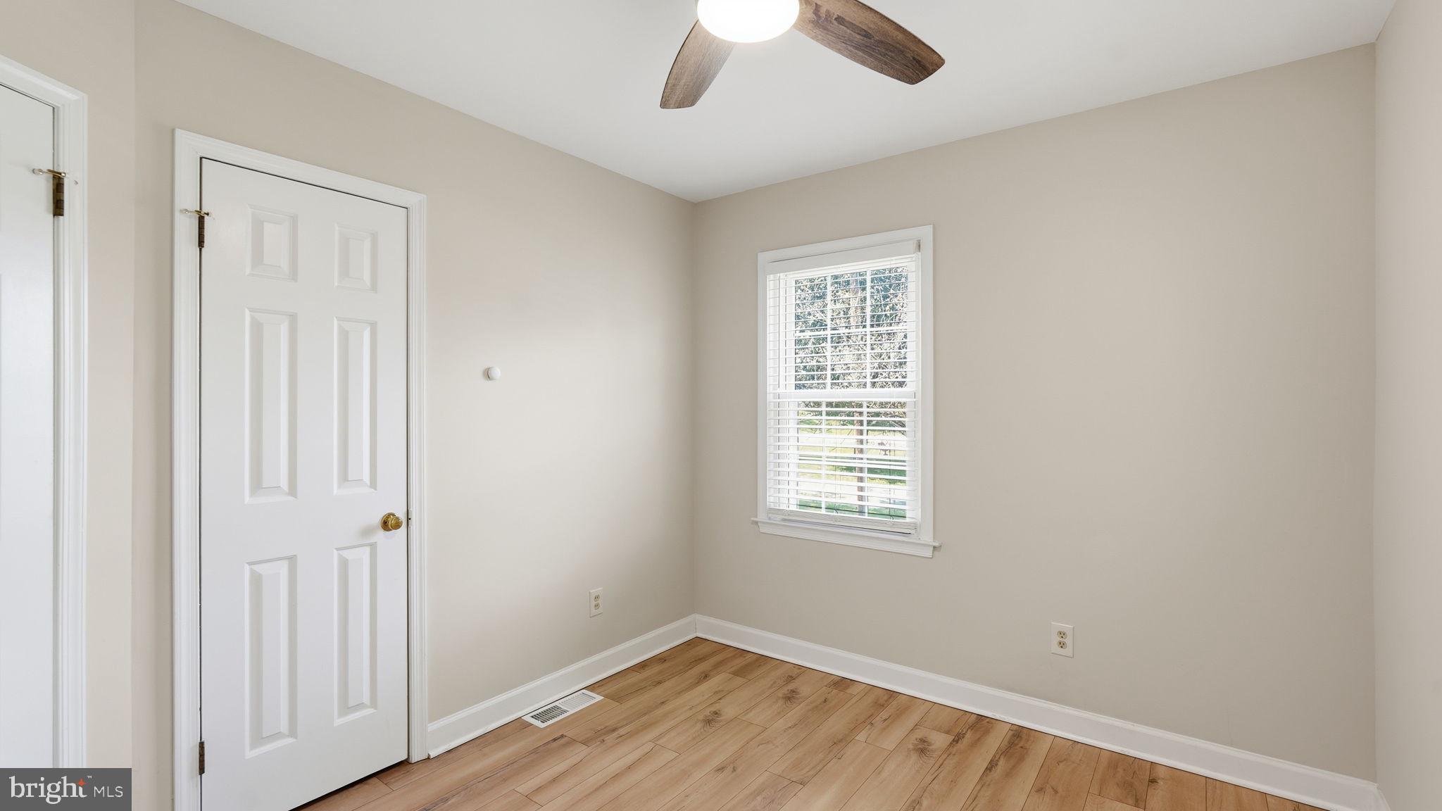 6499 Briggs Road Warrenton, VA 20187 - Photo 21 of 29 wooden floor in an empty room with a window