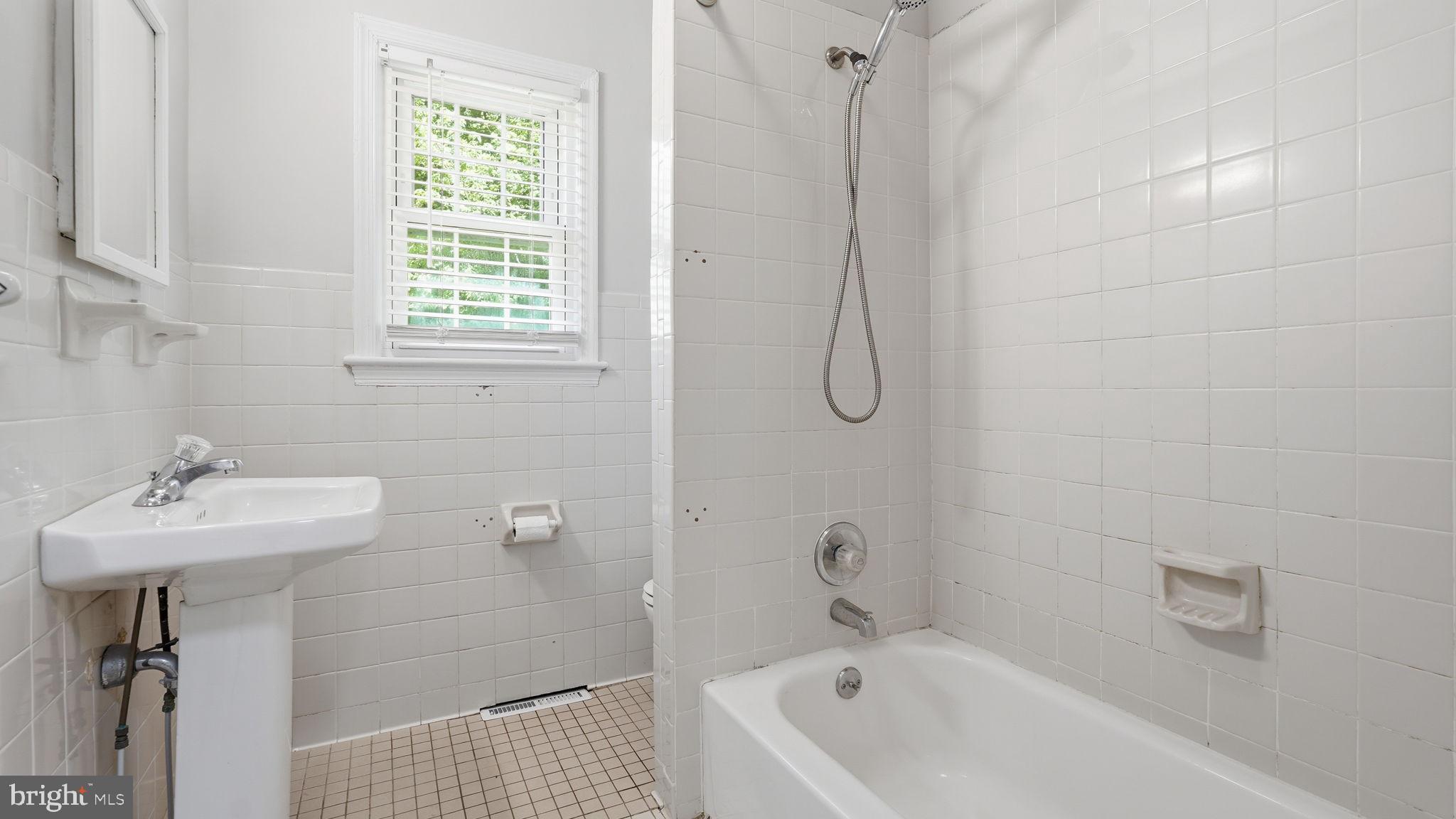 6499 Briggs Road Warrenton, VA 20187 - Photo 22 of 29 a bathroom with a sink a window and a shower