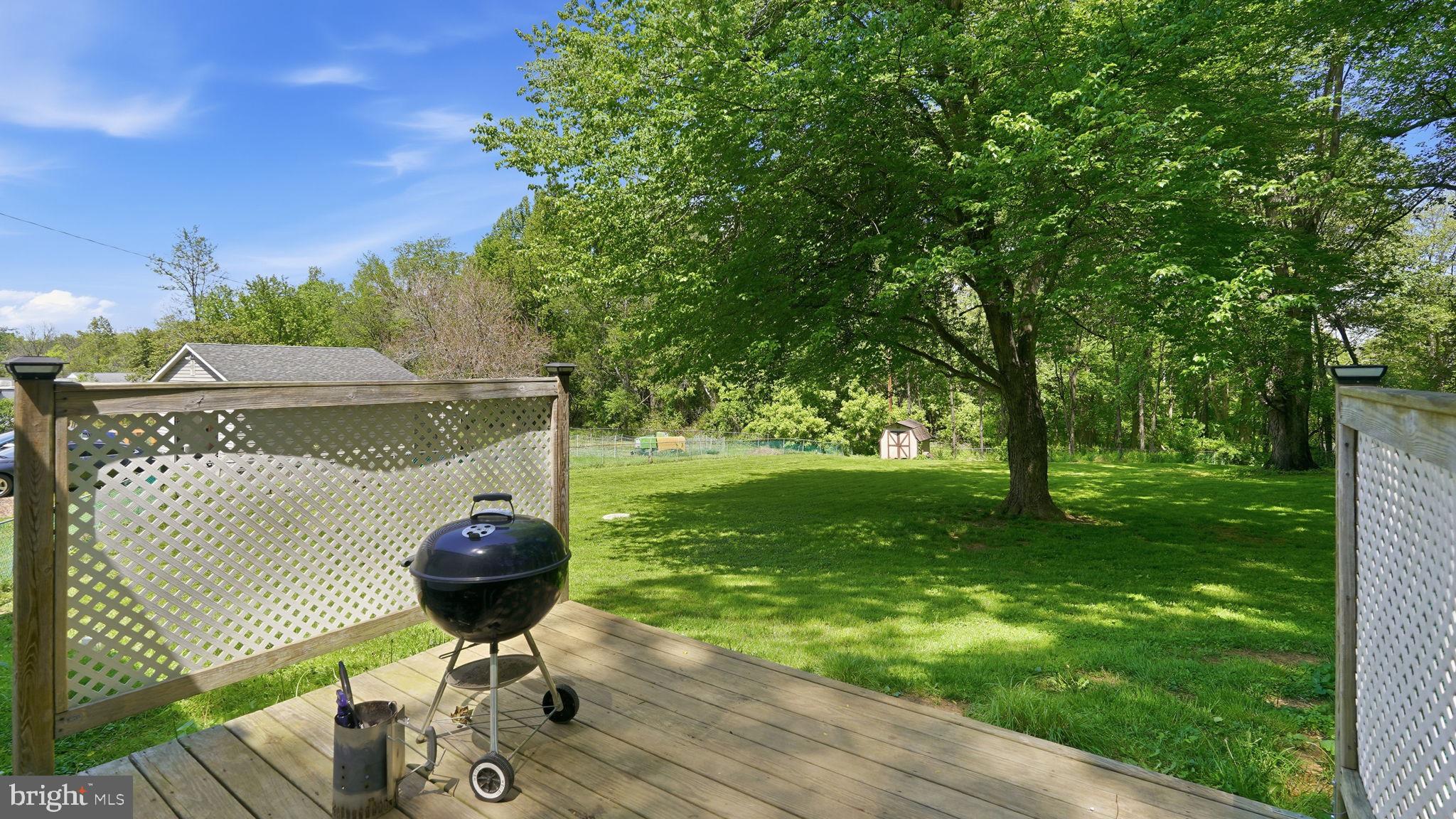6499 Briggs Road Warrenton, VA 20187 - Photo 25 of 29 a view of a table and chairs in backyard of the house