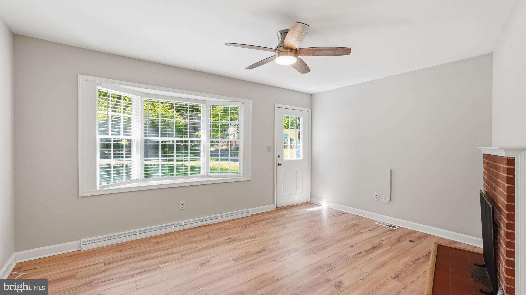 6499 Briggs Road Warrenton, VA 20187 - Photo 7 of 29 a view of empty room with wooden floor and fan