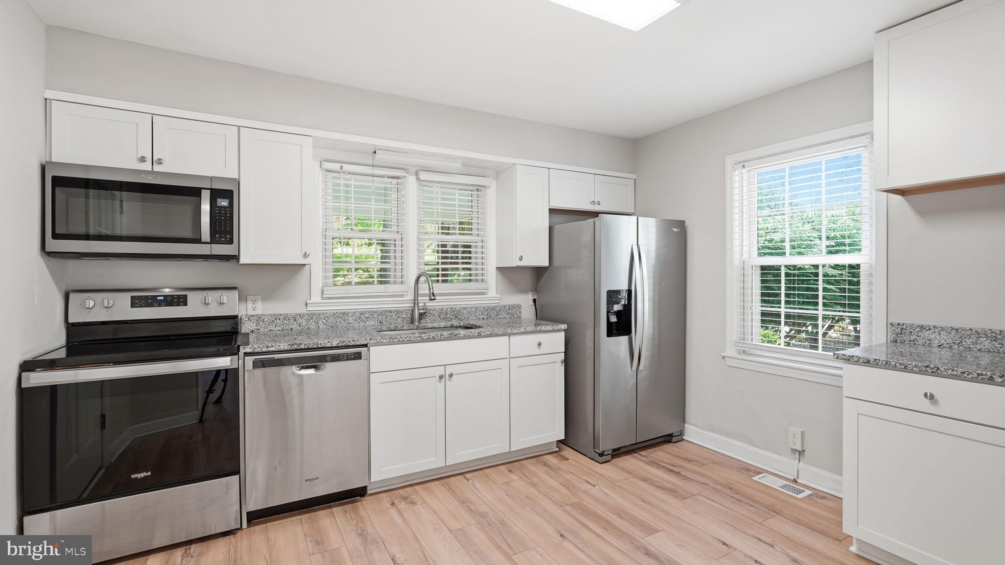 6499 Briggs Road Warrenton, VA 20187 - Photo 9 of 29 a kitchen with stainless steel appliances a stove a sink and a refrigerator