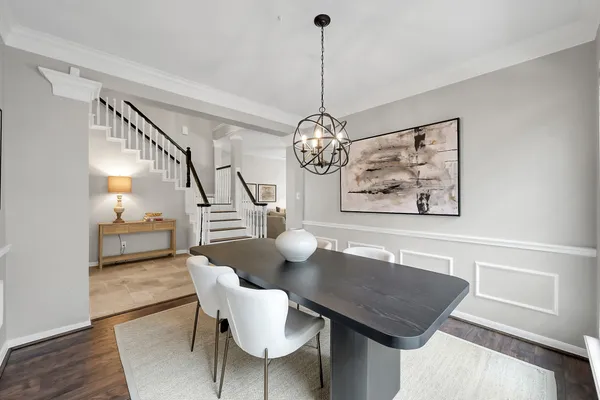 a view of a dining room with furniture wooden floor and a chandelier