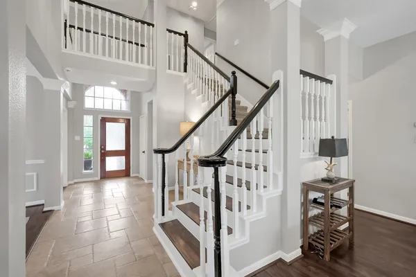 a view of entryway with wooden floor and stairs
