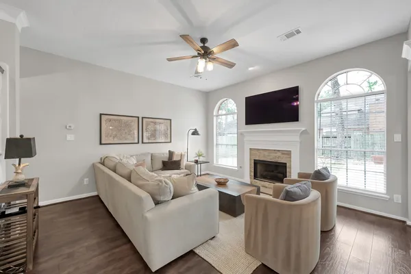 a living room with furniture a fireplace and a flat screen tv