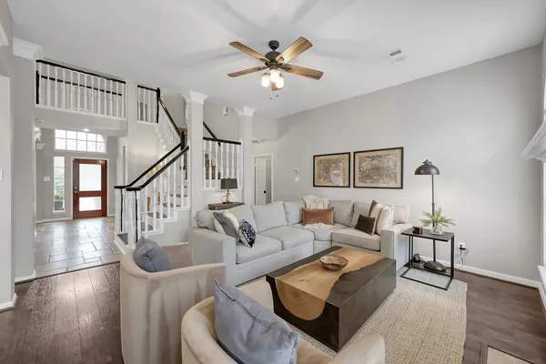 a living room with fireplace furniture and a wooden floor