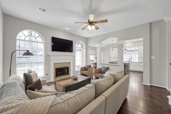a living room with furniture a fireplace and a flat screen tv