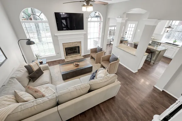 a living room with furniture a flat screen tv and a fireplace
