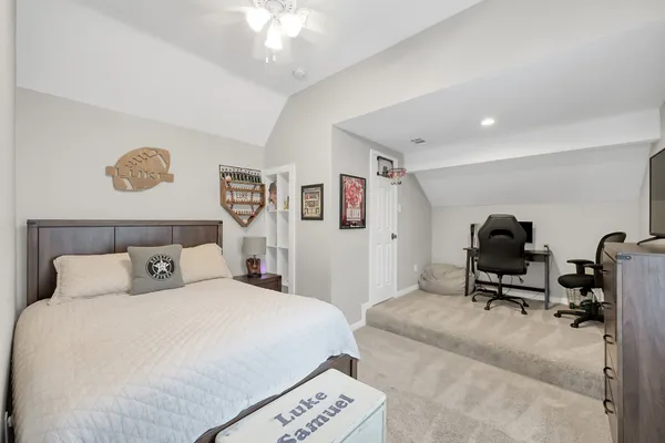 a bedroom with a bed and a chandelier