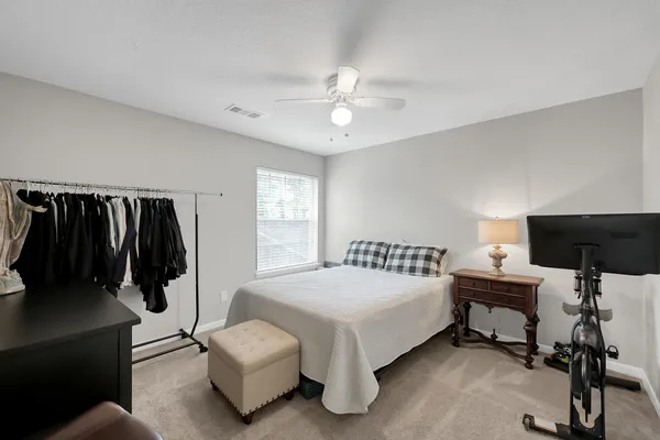 a bedroom with a bed and a chandelier