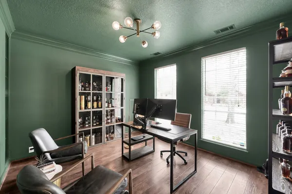 a workspace with furniture bookshelf and a window