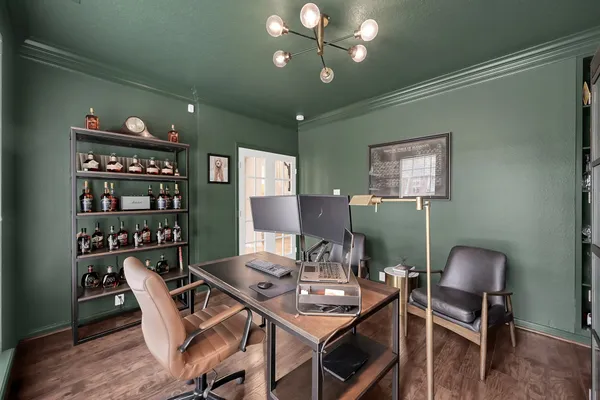 a workspace with furniture and chandelier