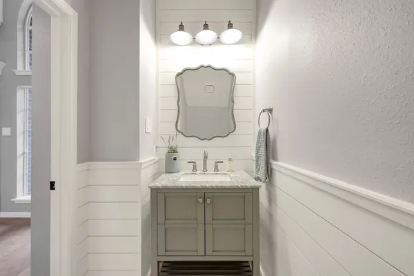 a bathroom with a sink and a mirror