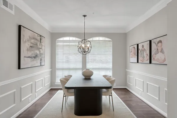 a view of a dining room with furniture wooden floor and a chandelier