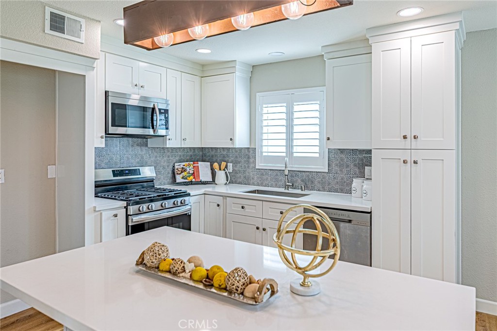 15510 Williams Street, Unit F Tustin, CA 92780 - Photo 7 of 34 Plenty of cabinetry with stainless steel appliances