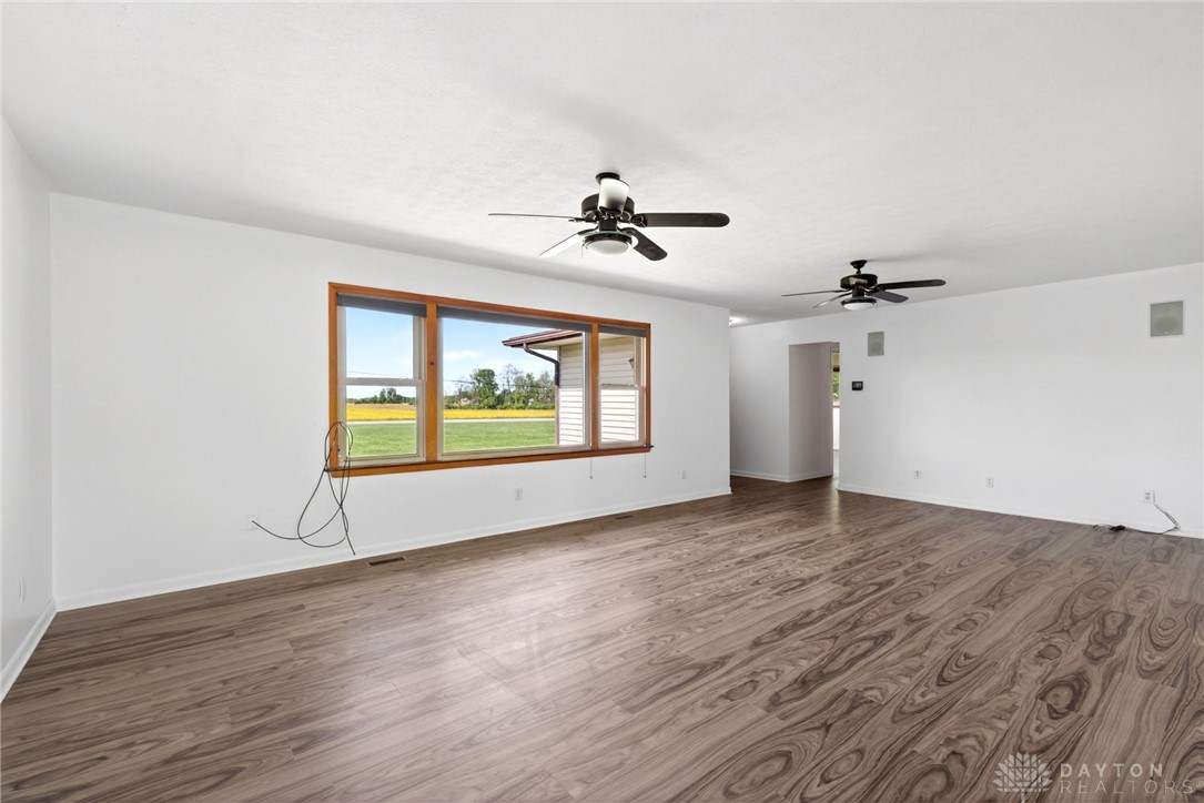 1005 Free Road New Carlisle, OH 45344 - Photo 8 of 43 This expansive room features beautiful flooring and large windows, offering abundant natural light and views.