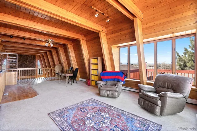 a living room with furniture a rug and a large window