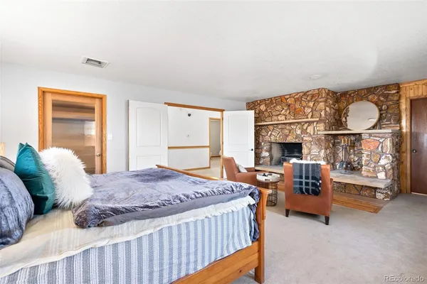 a bedroom with a bed and a fireplace