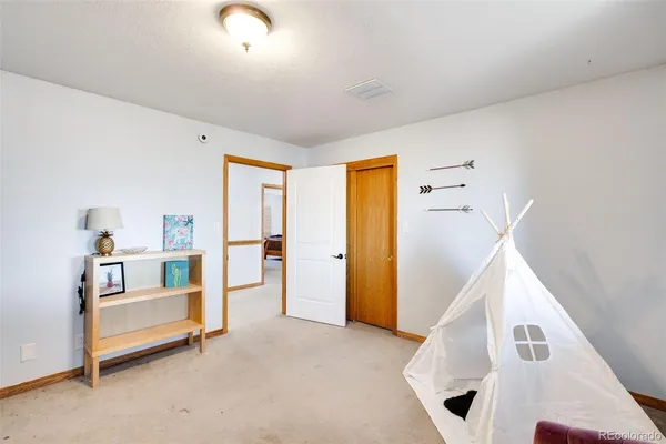 a view of a livingroom with furniture and staircase