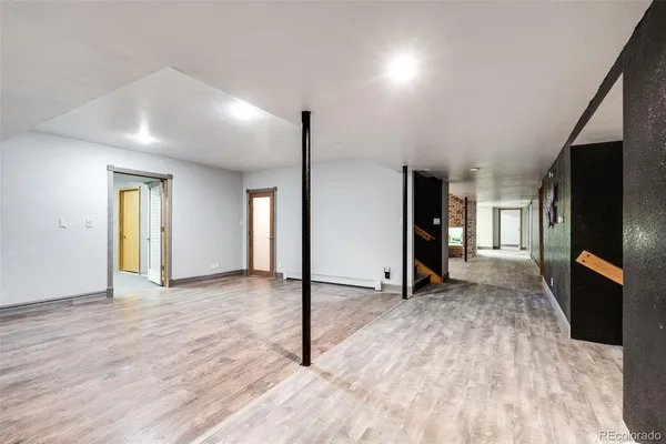 a view of empty room with wooden floor