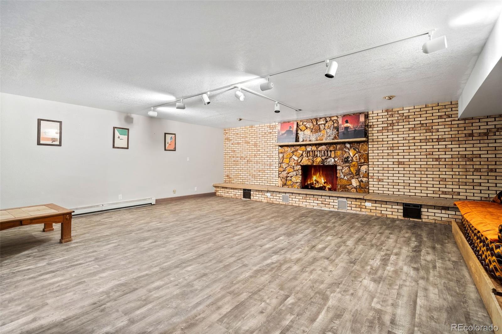 13231 Dillon Street Brighton, CO 80601 - Photo 35 of 49 an empty room with wooden floor and gym equipment