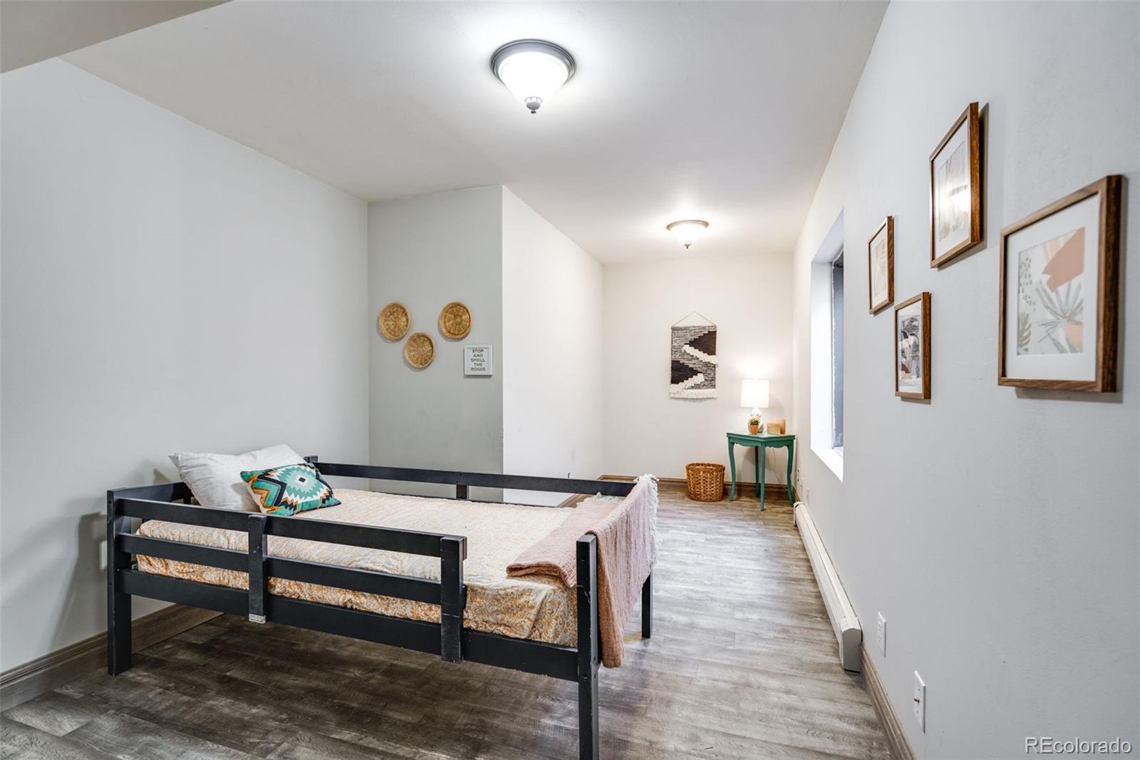 13231 Dillon Street Brighton, CO 80601 - Photo 40 of 49 a living room with furniture and a wooden floor