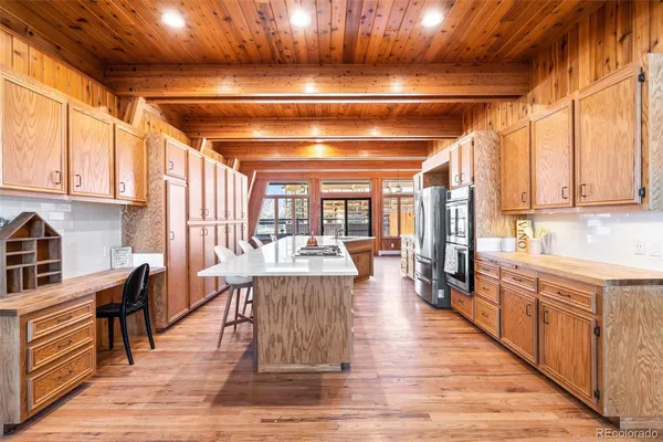 a open kitchen with stainless steel appliances granite countertop a stove and cabinets with wooden floor