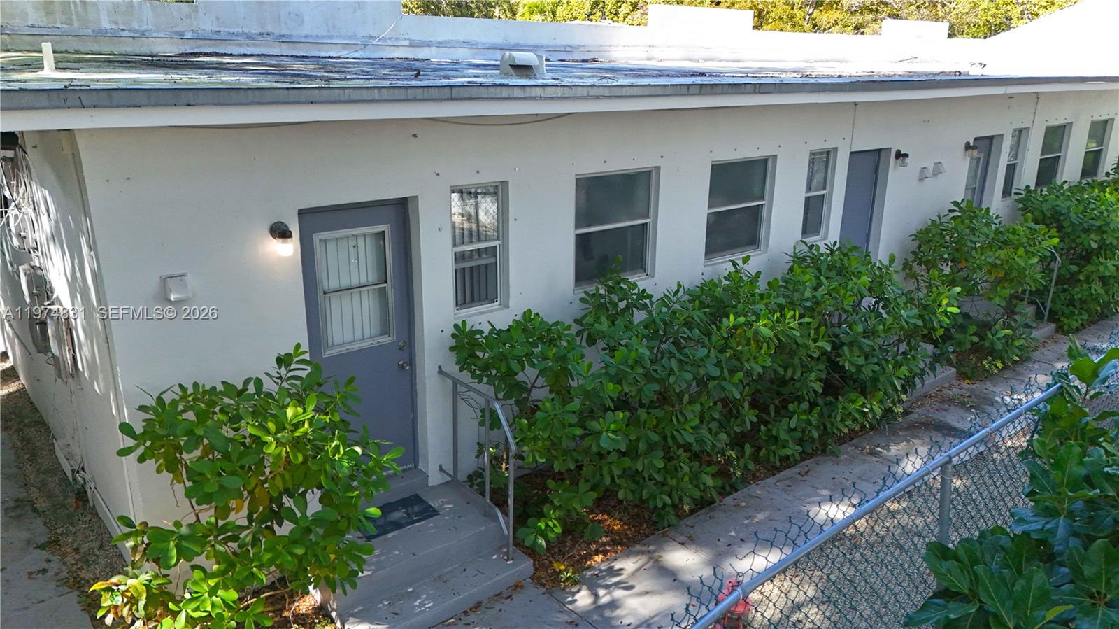 2825 Southwest 3rd Avenue Miami, FL 33129 - Photo 5 of 8 a front view of house and yard with green space