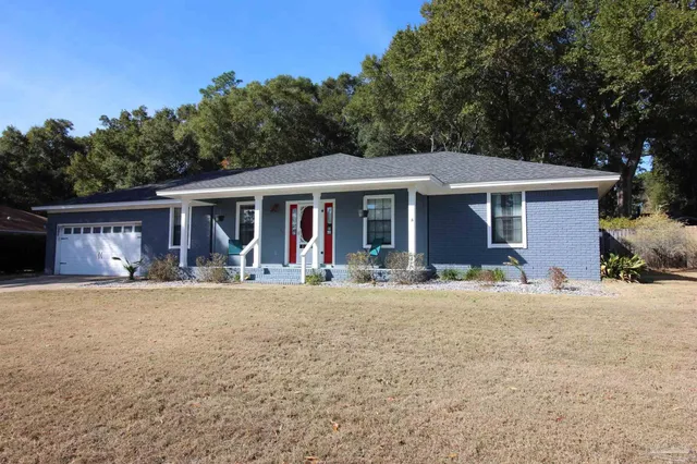 a front view of a house with yard patio and green space
