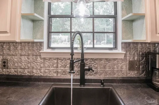 a kitchen with cabinets wooden floor and stainless steel appliances