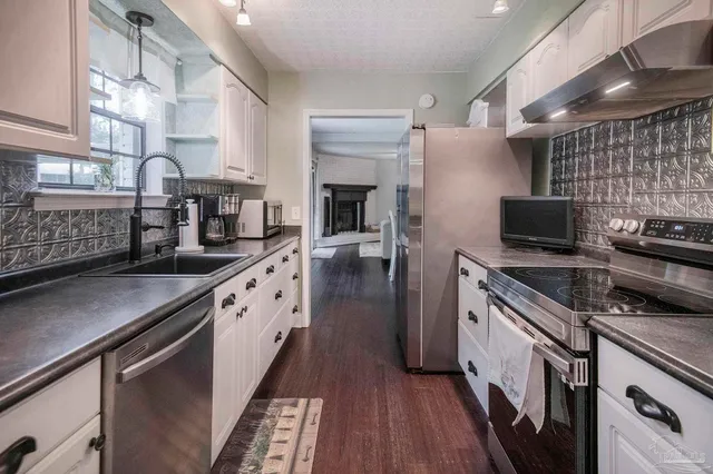 a bathroom with a granite countertop toilet a sink and a mirror